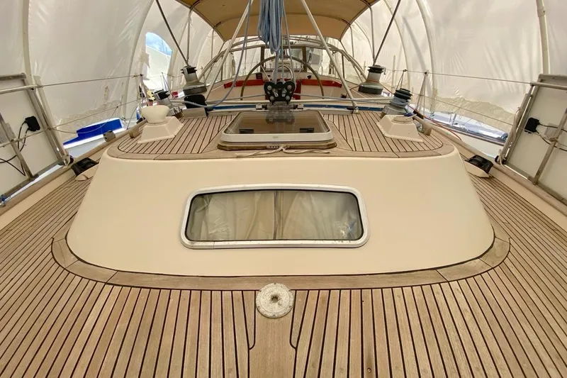 Challanger Yacht Photos Pics 1992 Hallberg-Rassy 45 yacht deck with teak wood finish and cabin window.