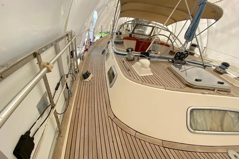 Challanger Yacht Photos Pics 1992 Hallberg-Rassy 45 yacht deck with teak finish and covered cockpit.