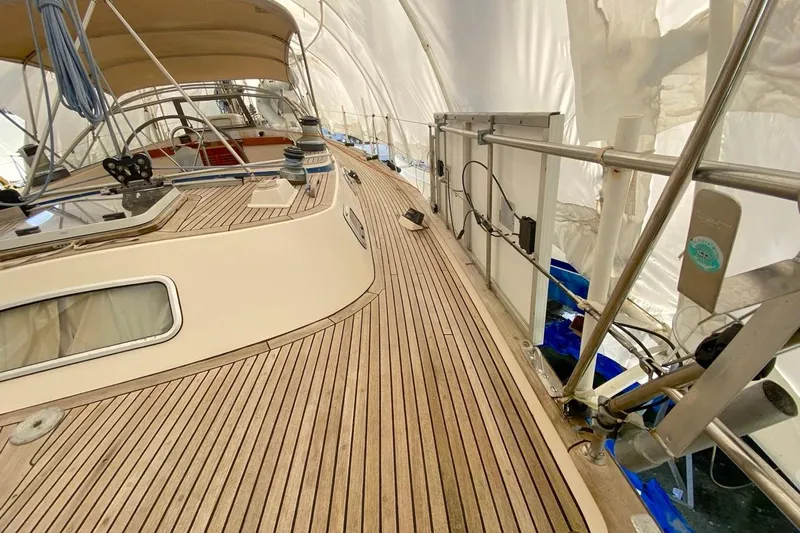Challanger Yacht Photos Pics 1992 Hallberg-Rassy 45 yacht deck with teak finish and covered cockpit.