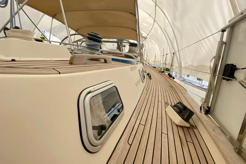 Challanger Yacht Photos Pics Deck view of 1992 Hallberg-Rassy 45 sailboat with teak wood finish and canopy.