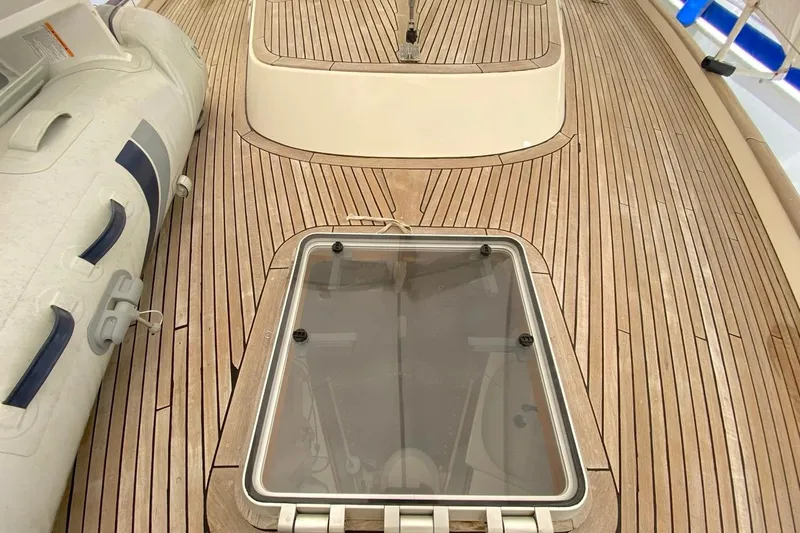 Challanger Yacht Photos Pics Teak deck of 1992 Hallberg-Rassy 45 sailboat with hatch and inflatable dinghy.