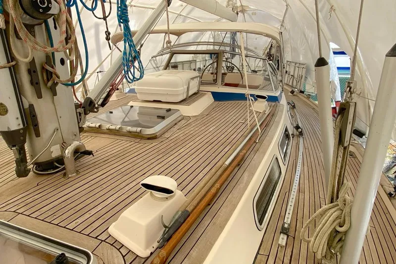 Challanger Yacht Photos Pics 1992 Hallberg-Rassy 45 sailboat deck with teak finish and rigging under cover.