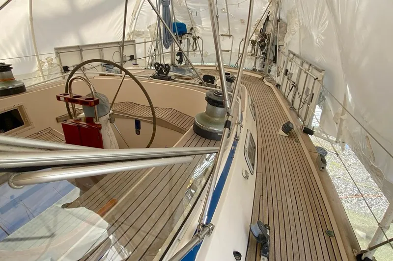 Challanger Yacht Photos Pics 1992 Hallberg-Rassy 45 sailboat interior with wooden deck and steering wheel.