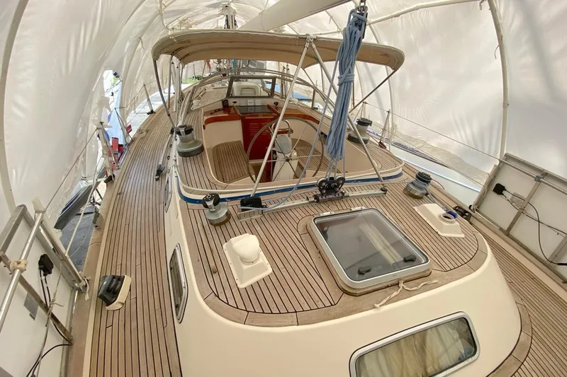 Challanger Yacht Photos Pics 1992 Hallberg-Rassy 45 sailboat deck with wooden finish under protective cover.