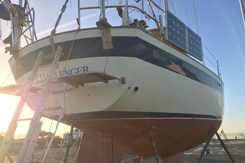 Challanger Yacht Photos Pics 1992 Hallberg-Rassy 45 sailboat on dry dock with solar panels, sunset background.