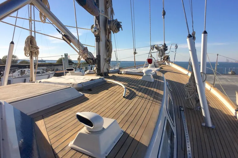 Challanger Yacht Photos Pics 1992 Hallberg-Rassy 45 sailboat deck with wooden finish, docked by the sea.