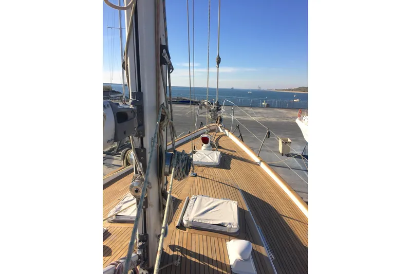 Challanger Yacht Photos Pics Deck view of a 1992 Hallberg-Rassy 45 sailboat with ocean backdrop.