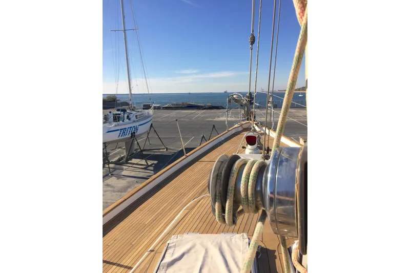 Challanger Yacht Photos Pics Deck view of 1992 Hallberg-Rassy 45 sailboat in a marina, clear sky.
