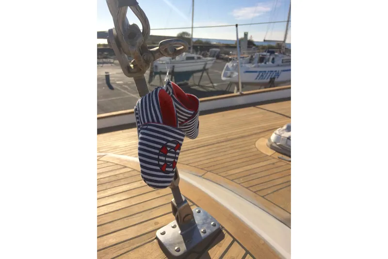 Challanger Yacht Photos Pics Baby shoes hanging on a 1992 Hallberg-Rassy 45 sailboat deck.