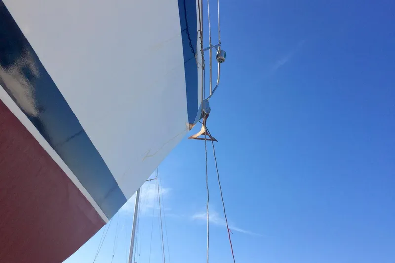 Challanger Yacht Photos Pics Close-up of 1992 Hallberg-Rassy 45 yacht bow against clear blue sky.