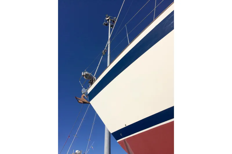 Challanger Yacht Photos Pics Sailboat Hallberg-Rassy 45, 1992 model, with blue and red accents against clear sky.