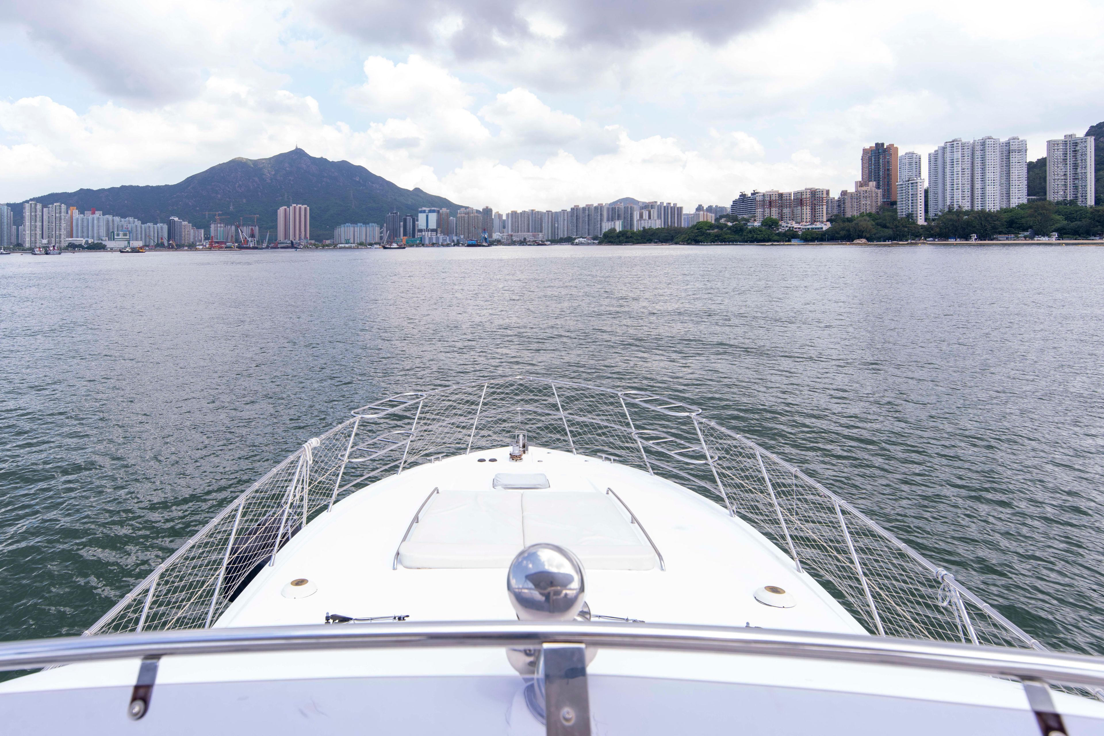 Bow of Ruby 52 yacht facing city skyline and mountains, 2009 model.
