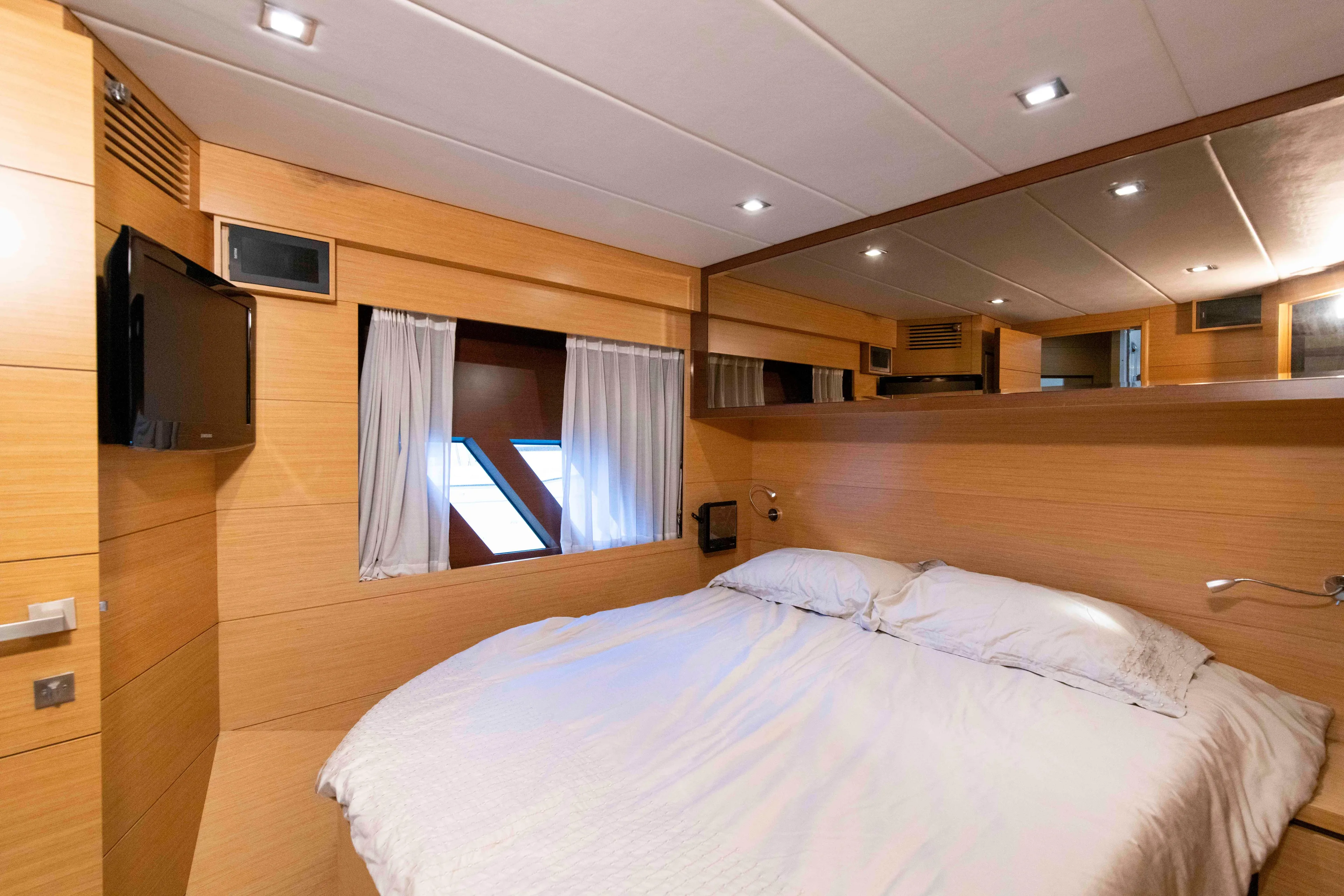 Luxurious Ruby 52 yacht bedroom interior, 2009 model, featuring wood paneling and modern amenities.