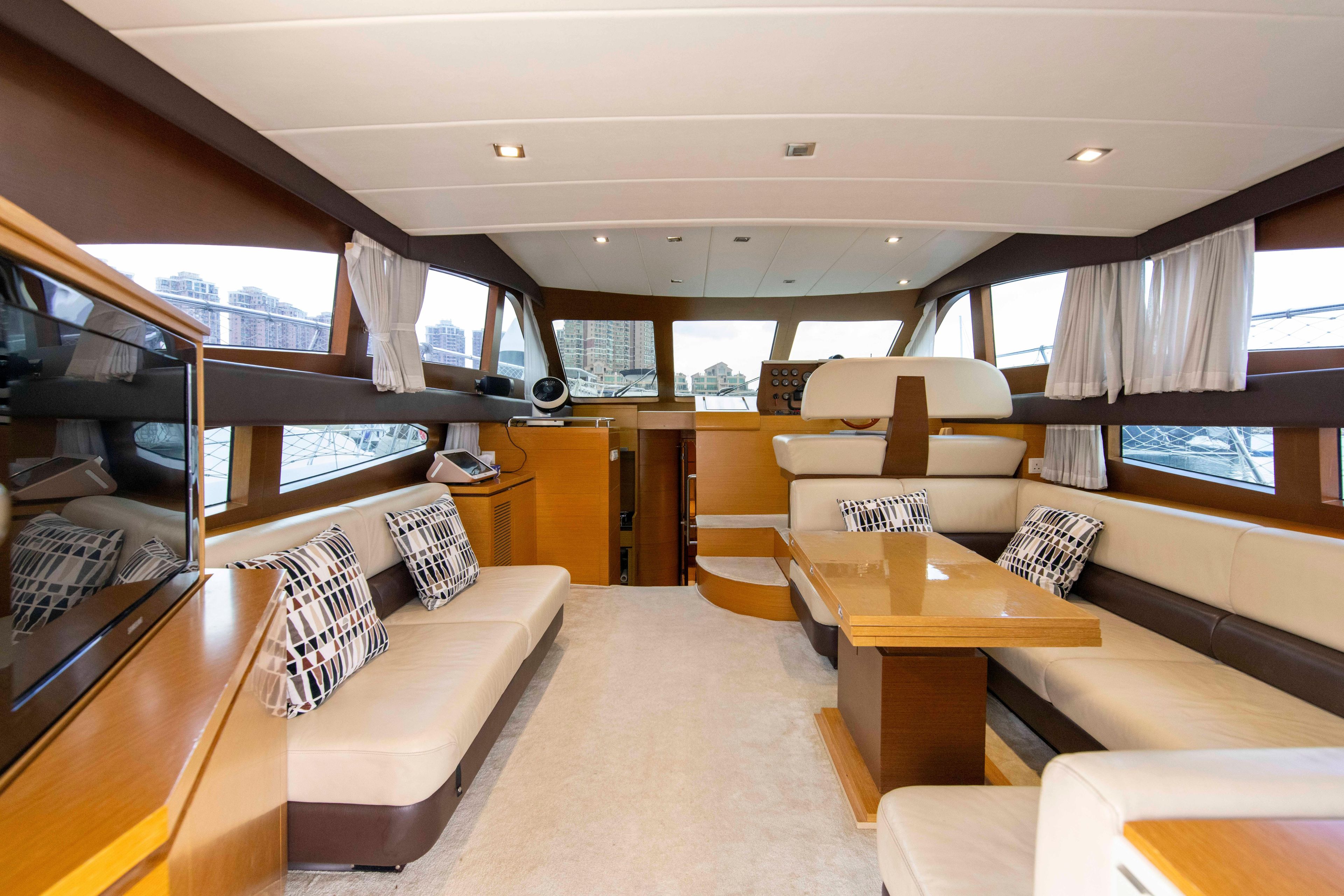 Luxurious interior of 2009 Ruby 52 yacht with modern seating and elegant decor.