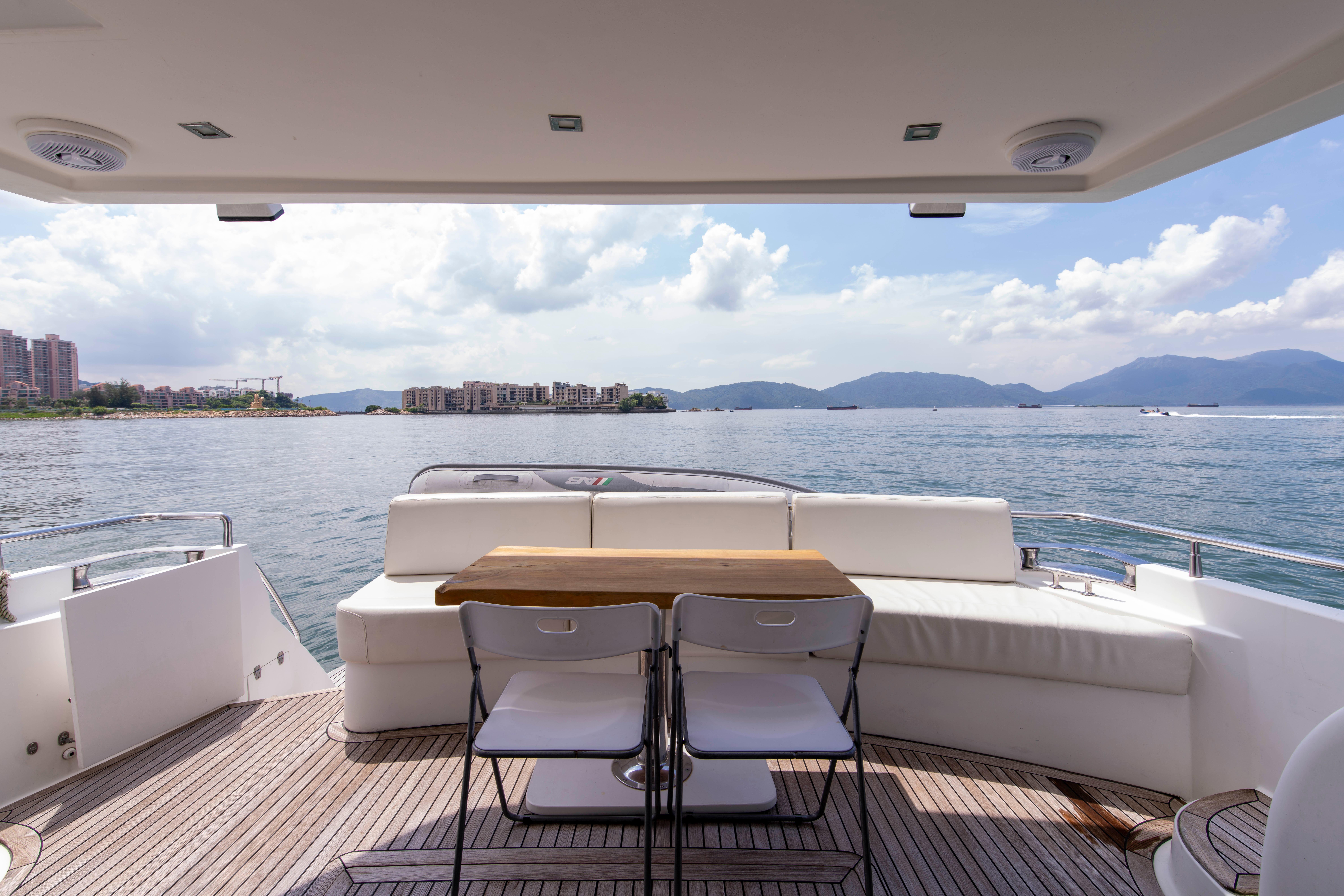 Luxury yacht Ruby 52 (2009) with scenic ocean view and comfortable seating area.