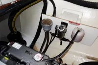 Engine compartment of 2021 Leopard 50 yacht, featuring hoses and mechanical components.
