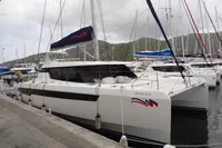 Leopard 50 catamaran docked at marina, 2021 model, with sails and scenic backdrop.