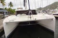 2021 Leopard 50 catamaran docked at marina with palm trees and hills in background.