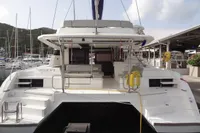 2021 Leopard 50 catamaran docked at marina, rear view with open deck and seating area.