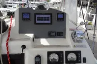 Control panel of a 2021 Leopard 50 yacht with navigation instruments and throttle levers.