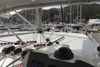 2021 Leopard 50 catamaran docked at marina with scenic hillside backdrop.