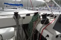 Sailing yacht deck with ropes and winches, Leopard 50, 2021 model, marina background.