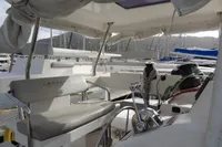 Leopard 50 catamaran cockpit with helm, ropes, and seating, docked in marina, 2021 model.