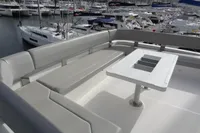 Luxurious seating area on 2021 Leopard 50 yacht, featuring sleek design and marina view.