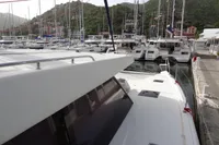 Leopard 50 catamaran docked in a marina, surrounded by other boats, 2021 model.