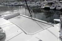 2021 Leopard 50 catamaran with netting, docked in a marina with other boats.
