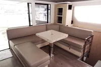 Modern interior of 2021 Leopard 50 yacht with beige seating and sleek table.