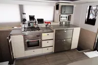 Modern kitchen in a 2021 Leopard 50 yacht with stainless steel appliances and sleek cabinetry.