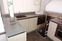 Modern kitchen in 2021 Leopard 50 yacht with sleek countertops and stainless steel appliances.