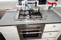 Modern kitchen with Miele gas stove and oven, featuring a stainless steel kettle.