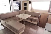 Luxurious interior of 2021 Leopard 50 yacht with modern seating and dining area.