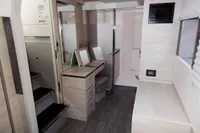 Modern interior of 2021 Leopard 50 yacht with stairs, vanity, and bathroom.