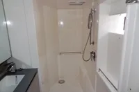 Modern bathroom with shower in 2021 Leopard 50 yacht, featuring sleek fixtures and white interior.