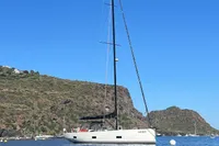 Sailing yacht Solaris 58 (2016) anchored in a scenic coastal bay.