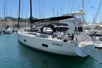 Sleek 2016 Solaris 58 yacht docked in a marina, surrounded by other boats.