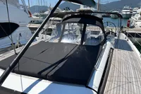 Luxurious 2016 Solaris 58 yacht docked at marina, featuring sleek design and spacious deck.