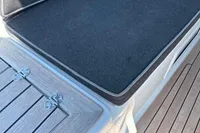 Cushioned seating and wooden deck on 2016 Solaris 58 yacht.