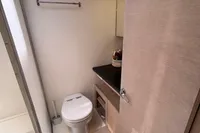 Compact bathroom in a 2016 Solaris 58 yacht, featuring modern fixtures and light wood finishes.