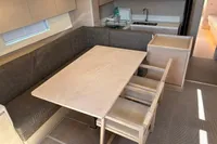 Luxurious interior of 2016 Solaris 58 yacht with dining area and modern kitchen.