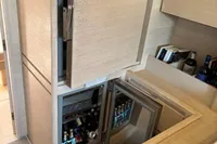 Luxurious interior of 2016 Solaris 58 yacht with open cabinets and beverage storage.