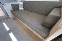 Luxurious interior of 2016 Solaris 58 yacht with sleek gray sofa and cushions.