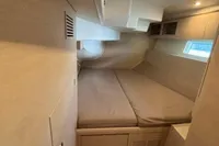 Interior cabin of 2016 Solaris 58 yacht with beige bedding and modern design.