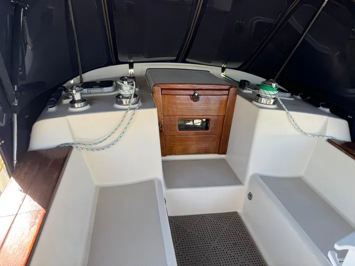 Otter II Yacht Photos Pics 1999 Island Packet 45 sailboat cockpit with winches, seating, and wooden storage compartment.