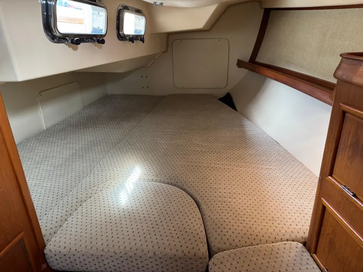 Otter II Yacht Photos Pics Interior cabin of 1999 Island Packet 45 sailboat with cushioned sleeping area.