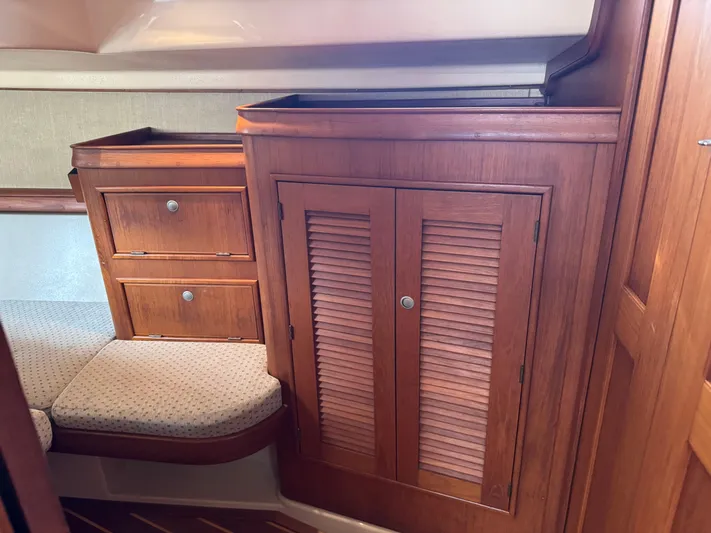 Otter II Yacht Photos Pics Interior of 1999 Island Packet 45 sailboat with wooden cabinetry and cushioned seating.