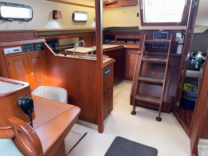 Otter II Yacht Photos Pics Interior of 1999 Island Packet 45 sailboat with wooden cabinetry and stairs.